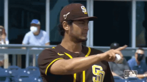 A Baseball Player Wearing A San Diego Padres Uniform Is Pointing GIF