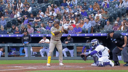 A Baseball Player Wearing A San Diego Padres Uniform Stands At Home Plate Ready To Bat GIF