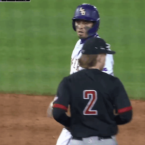 A Baseball Player Wearing A Tigers Jersey Talks To Another Player GIF