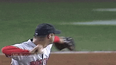 a baseball player wearing a wakefield jersey is throwing a ball .