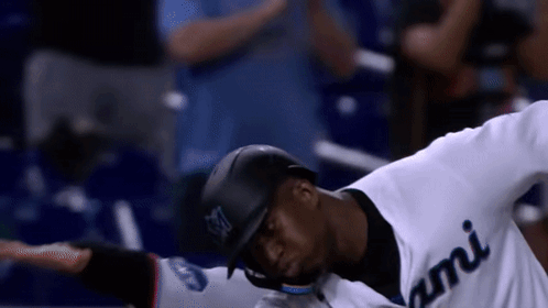 A Baseball Player Wearing A White Jersey With Miami On It GIF