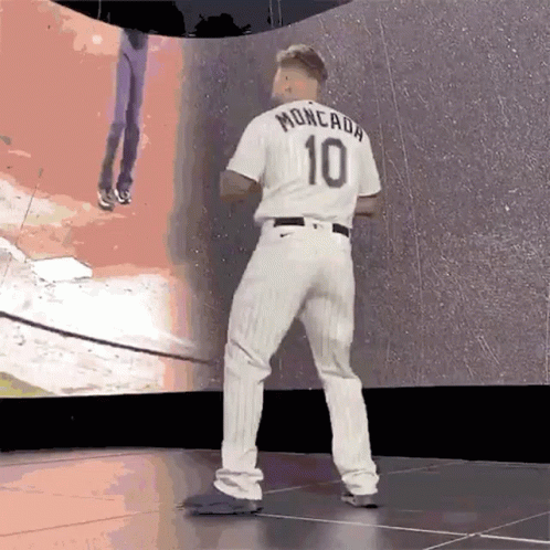 A Baseball Player Wearing A White Jersey With The Number 10 On It GIF