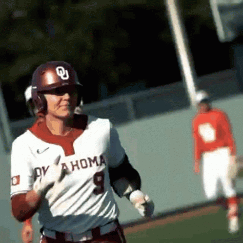A Baseball Player Wearing A White Oklahoma Jersey Is Running On The Field GIF