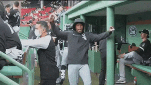 A Baseball Player Wearing A White Sox Hoodie Is Dancing In The Dugout GIF