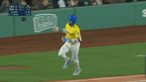 A Baseball Player Wearing A Yellow Jersey That Says Boston On It GIF