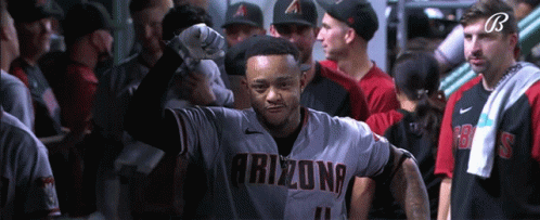 A Baseball Player Wearing An Arizona Jersey Stands In A Locker Room GIF