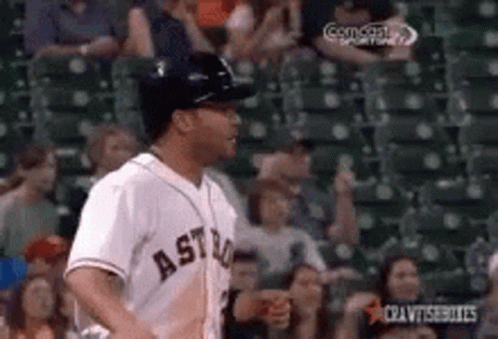 A Baseball Player Wearing An Astros Jersey Is Running In Front Of A Crowd . GIF