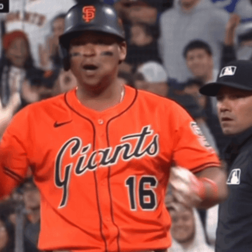 A Baseball Player Wearing An Orange Jersey With The Number 16 On It GIF