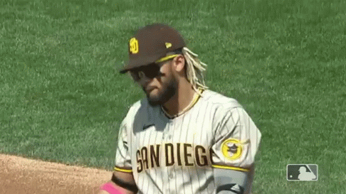 A Baseball Player Wearing Sunglasses And A San Diego Jersey Is Standing On The Field . GIF