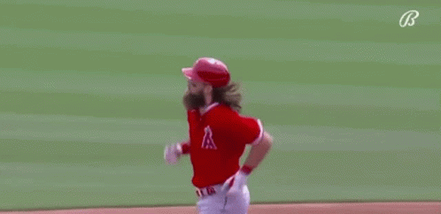 A Baseball Player With A Beard Is Running On A Baseball Field . GIF