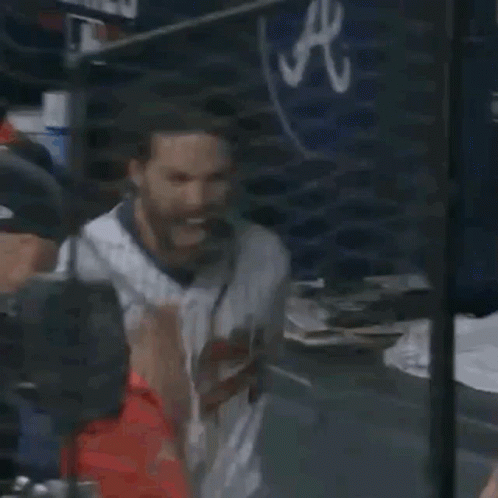 A Baseball Player With A Beard Is Sitting In The Dugout At A Game . GIF