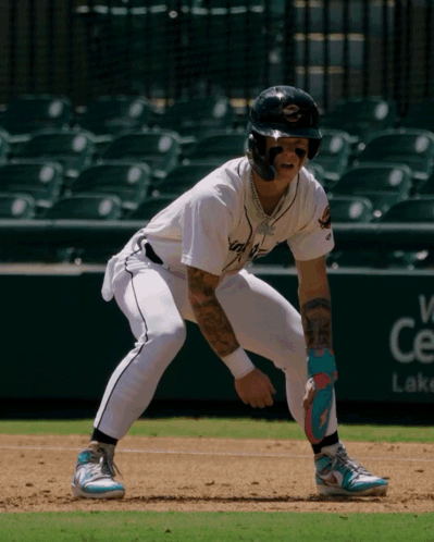 A Baseball Player With A Tattoo On His Arm Stands On The Base GIF