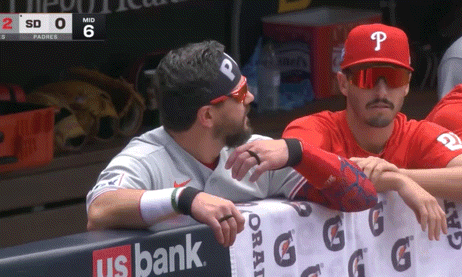 A Baseball Player With The Letter P On His Hat Talks To Another Player GIF