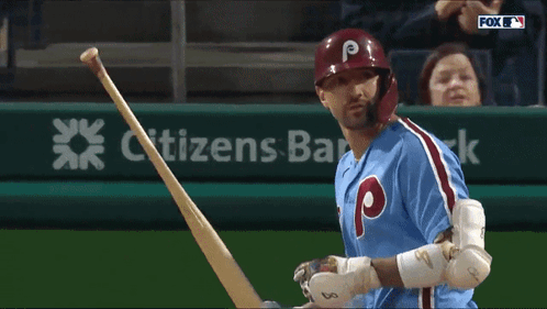 a baseball player with the letter p on his helmet holds his bat