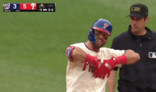 A Baseball Player With The Letter P On His Helmet Stands Next To A Referee GIF