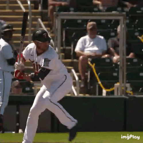A Baseball Player With The Letter T On His Jersey Swings At A Pitch GIF