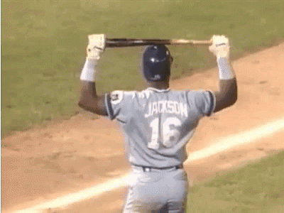 A Baseball Player With The Name Jackson On His Back Is Holding A Bat Over His Head GIF