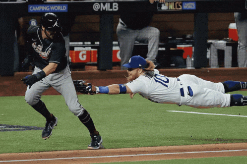A Baseball Player With The Number 10 On His Jersey Sliding Into Base GIF