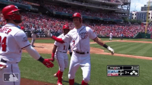 A Baseball Player With The Number 14 On His Jersey Is Hugging Another Player GIF