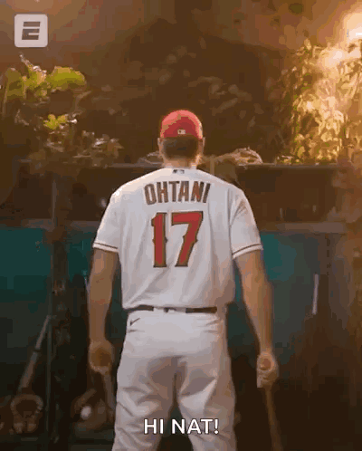 A Baseball Player With The Number 17 On His Back Is Holding A Bat And Says Hi Nat . GIF