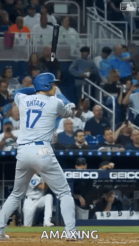 A Baseball Player With The Number 17 On His Jersey Is Swinging His Bat GIF