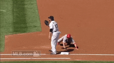 A Baseball Player With The Number 17 On His Jersey Is Trying To Catch A Ball . GIF