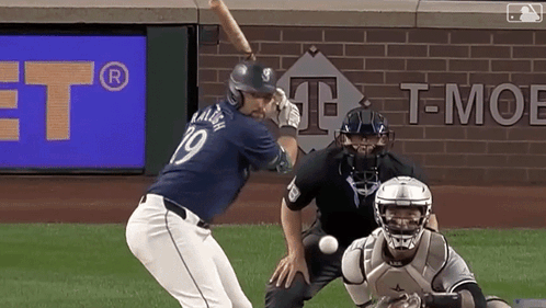 A Baseball Player With The Number 19 On His Jersey Swings At A Ball GIF