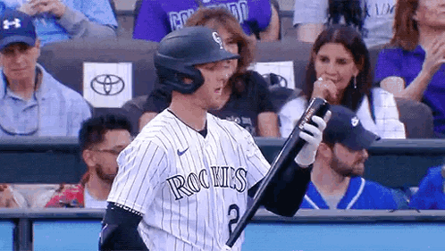 A Baseball Player With The Number 2 On His Jersey Is Holding A Bat . GIF