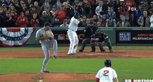 a baseball player with the number 2 on his jersey swings at a pitch