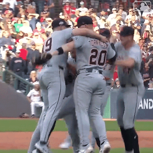A Baseball Player With The Number 20 On His Back Is Hugging Another Player GIF