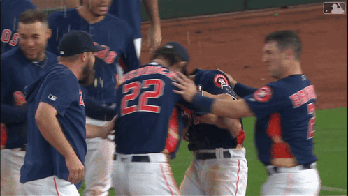 A Baseball Player With The Number 22 On His Back Is Hugged By His Teammates GIF