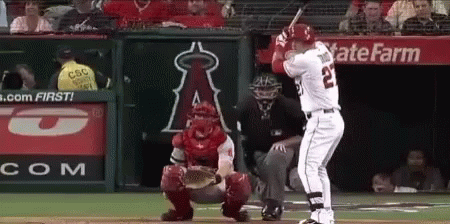 A Baseball Player With The Number 22 On His Jersey Is Swinging His Bat GIF