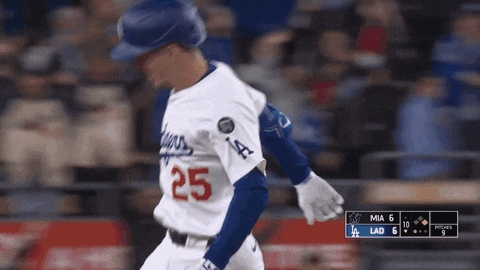 A Baseball Player With The Number 25 On His Jersey Is Running GIF
