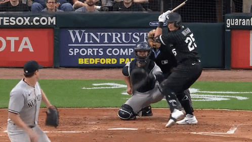 A Baseball Player With The Number 25 On The Back Of His Jersey Swings At A Pitch GIF
