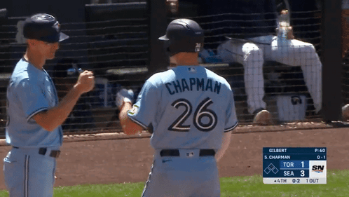 A Baseball Player With The Number 26 On His Back Shakes Hands With Another Player GIF