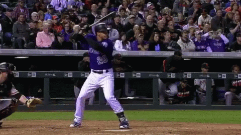A Baseball Player With The Number 28 On His Jersey Swings His Bat GIF