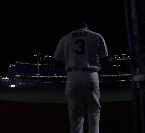 A Baseball Player With The Number 3 On His Jersey Is Running On A Field At Night GIF