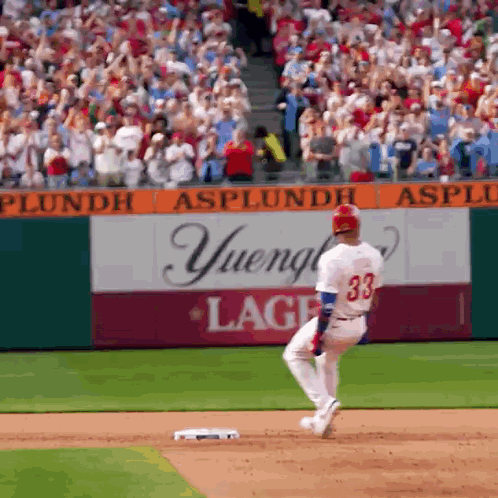 A Baseball Player With The Number 33 On His Jersey Is Running To Base GIF