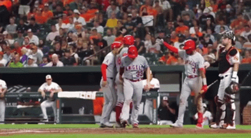A Baseball Player With The Number 35 On His Jersey Is Being Helped By His Teammates GIF