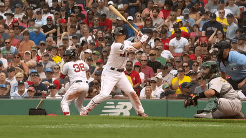 A Baseball Player With The Number 38 On His Back Is Swinging His Bat GIF