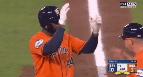 A Baseball Player With The Number 44 On His Jersey Is High Fiving Another Player GIF