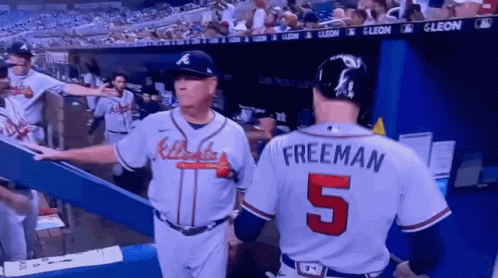 A Baseball Player With The Number 5 On His Back Talks To Another Player GIF