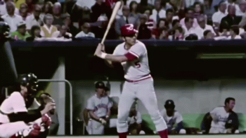 A Baseball Player With The Number 5 On His Jersey Is Swinging At A Ball GIF