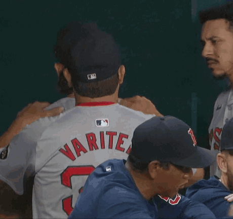 A Baseball Player With The Number 52 On His Jersey Is Hugging Another Player GIF