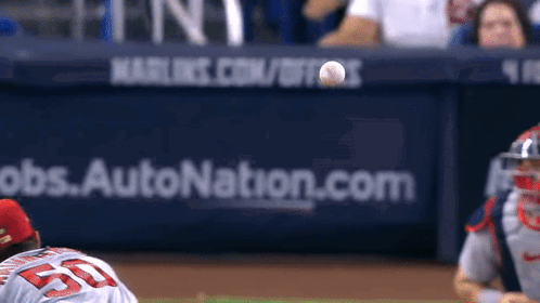 A Baseball Player With The Number 55 On His Jersey Is About To Catch A Ball GIF