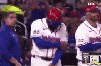 A Baseball Player With The Number 7 On His Helmet Is Being Hugged By Another Player GIF