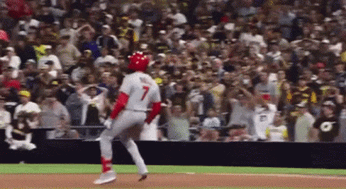 A Baseball Player With The Number 7 On His Jersey Is Running Towards The Base GIF