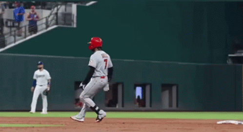 A Baseball Player With The Number 7 On His Jersey Is Standing On The Base GIF