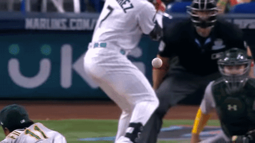 A Baseball Player With The Number 7 On His Jersey Is Swinging At A Ball GIF