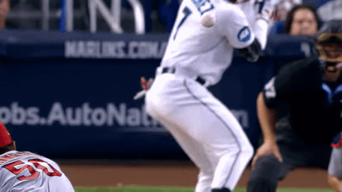 A Baseball Player With The Number 7 On His Jersey Swings At The Ball GIF